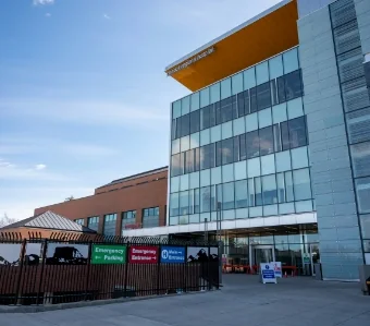 Hospital building entrance with emergency signage | Associated Nephrology Consultants | Maplewood MN