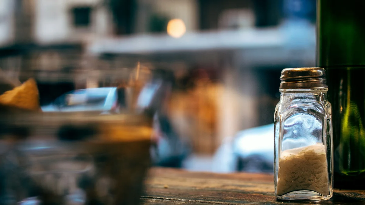 Glass salt shaker on a wooden table