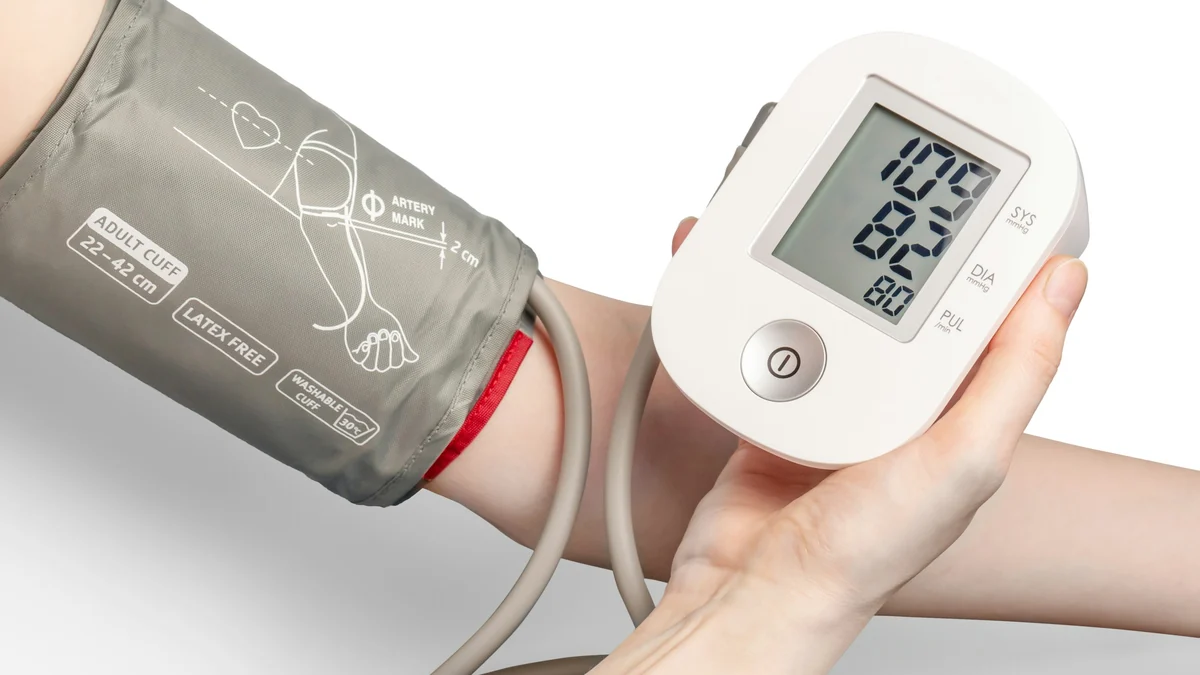Home blood pressure monitor and cuff on an arm